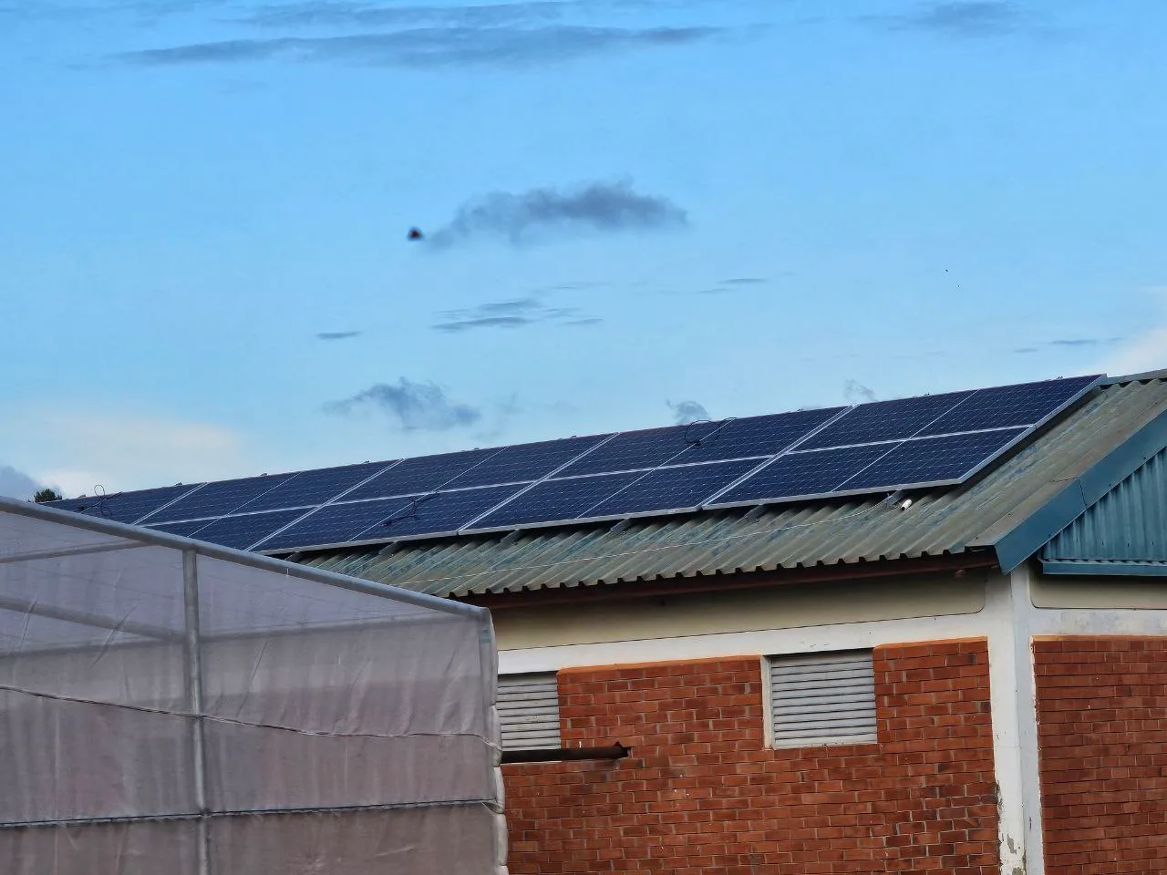 Solar panels on the roof of a brick building